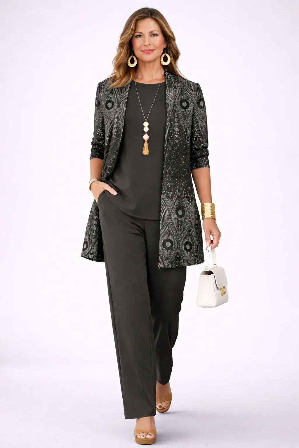 Annika black and silver paisley longline cardigan worn over a black round-neck top and wide-leg trousers