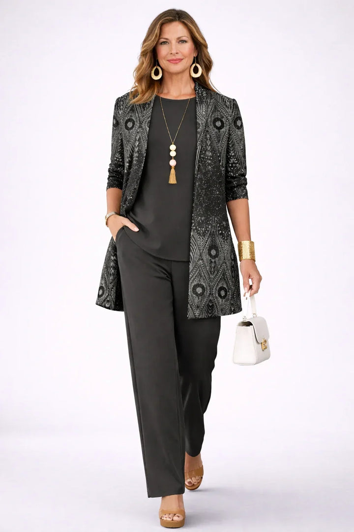 Annika black and silver paisley longline cardigan worn over a black round-neck top and wide-leg trousers