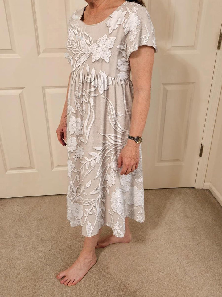 Delilah grey floral short-sleeve midi dress worn with bare feet, side view