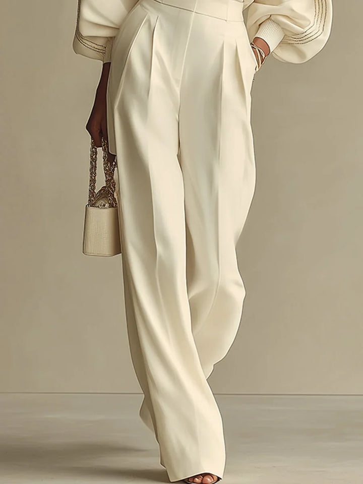 Elsbeth wide-leg pant set in ivory, detail of pleated high-waisted pants and ribbed sleeves